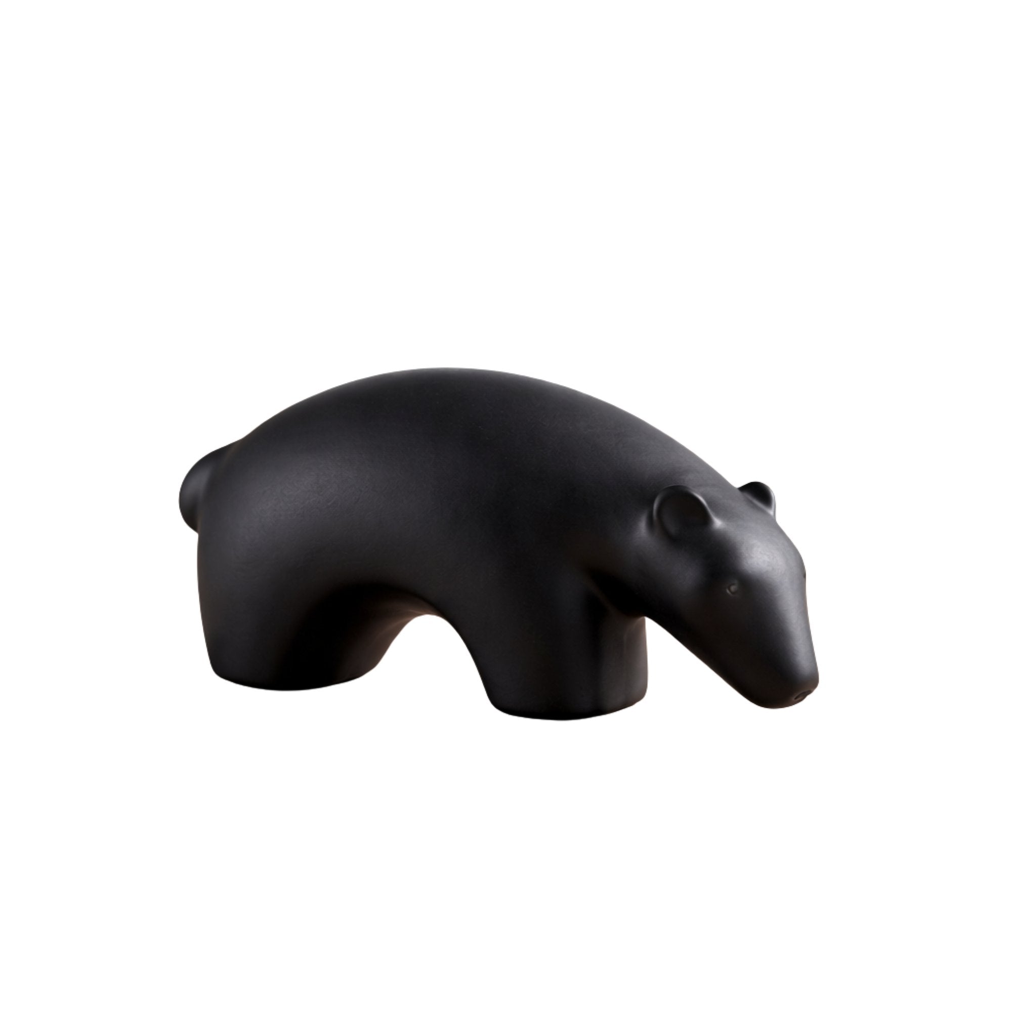 Minimalist matte black ceramic bear sculpture set on wooden surface 