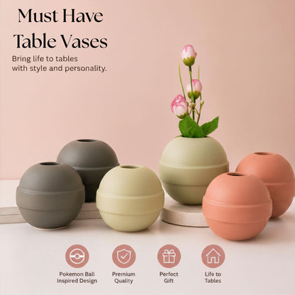 Modern ceramic Pokémon ball vase with baby breath flowers on wooden desk in aesthetic home interior