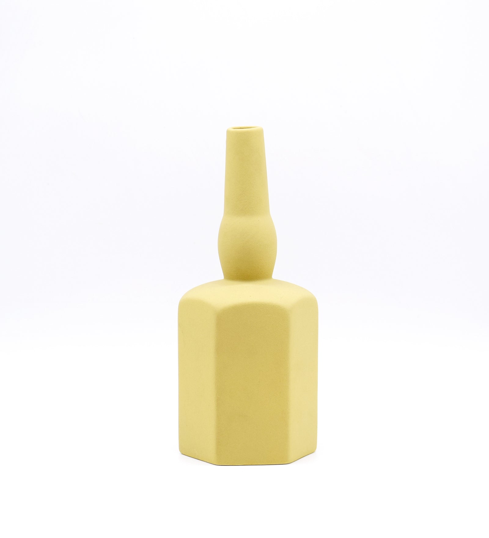 Luxury ceramic bottle-shaped vase with matte finish styled on a beige travertine console table in a modern Scandinavian-inspired interior with olive branches and minimalist décor.