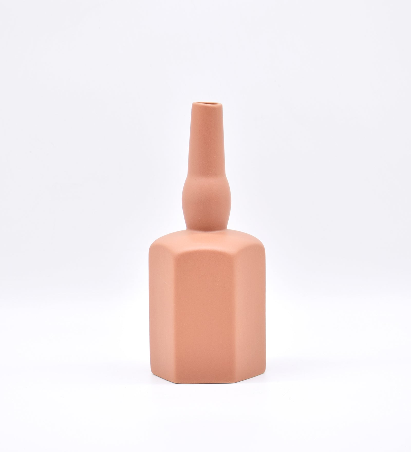 Luxury ceramic bottle-shaped vase with matte finish styled on a beige travertine console table in a modern Scandinavian-inspired interior with olive branches and minimalist décor.