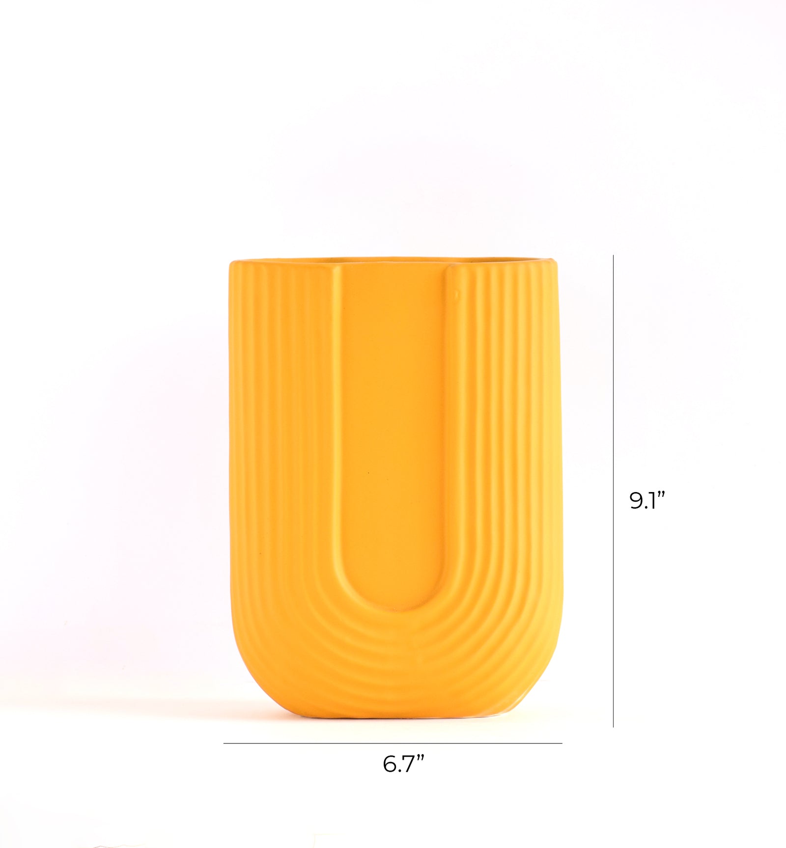Luxury U-shaped ceramic flower vase with sculptural modern design styled in an elegant contemporary living room interior.